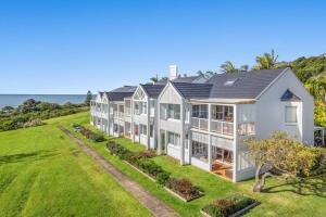 an exterior view of a large house with a lawn at Quarterdeck Unit 2 - Lennox Head in Lennox Head