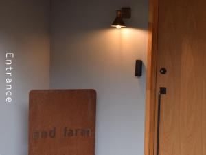 a room with a door and a light on the wall at and farmクラインガルテン in Nirasaki