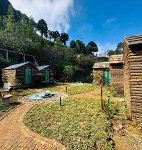 a view of a yard with two huts at Homestay26 in Bắc Yên