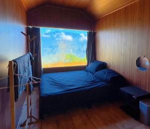 a small bed in a room with a window at Homestay26 in Bắc Yên