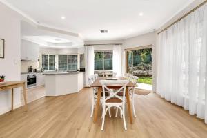a kitchen and dining room with a table and chairs at The Alderstone - Serene Haven in the Adelaide Hills in Aldgate