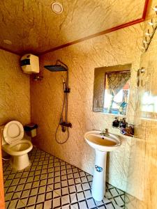 a bathroom with a sink and a toilet at Homestay26 in Bắc Yên
