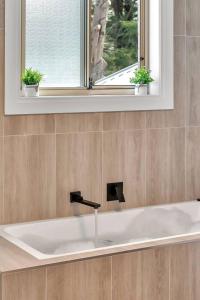 a white sink in a bathroom with a window at The Alderstone - Serene Haven in the Adelaide Hills in Aldgate +21 photos