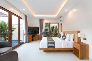 a bedroom with a large bed and a television at Villa Mia Seminyak - Boutique Villas - I in Seminyak +45 photos