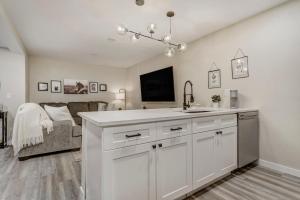 a kitchen with a sink and a living room with a couch at 4925 Pike Unit2 in Cascade-Chipita Park +18 photos