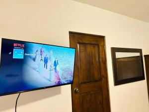 a flat screen tv hanging on a wall at Large family house in Cabo , pet friendly in Cabo San Lucas