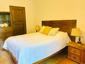 a bedroom with a large white bed with yellow pillows at Large family house in Cabo , pet friendly in Cabo San Lucas