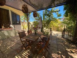a wooden table and chairs on a patio at Large family house in Cabo , pet friendly in Cabo San Lucas