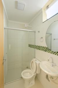 a bathroom with a toilet and a sink at Nova Jerusalém Hotel in Goiânia
