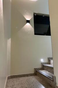 a stairway with a television on the wall at Nova Jerusalém Hotel in Goiânia +16 photos