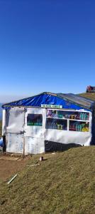 a refrigerator is covered in a tarp in a field at The Royal Roast in Shoja