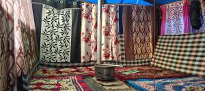 a room with curtains and rugs on the floor at The Royal Roast in Shoja