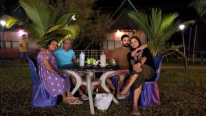 a group of people sitting around a table at night at Chanaka Eco Camp ( Adventure Assam ) in Pakariāmukh