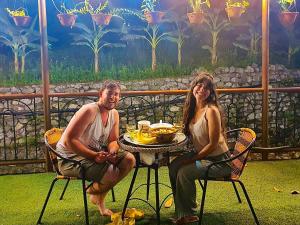 a man and a woman sitting at a table at Papa's Garden - Homestay Hà Giang in Làng Me +26 photos