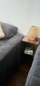 a couch with a side table with a lamp on it at Micha Loft in Puerto Natales