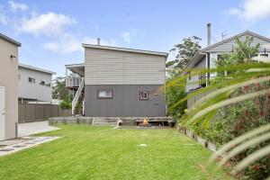 a home with a yard with a house at Conjola Escapes in Green Island