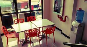 a room with a table and chairs and a window at Cityinn Hotel in Zamboanga