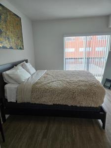 een bed in een kamer met een groot raam bij Downtown 2 bedroom apartment in Los Angeles +2 foto's