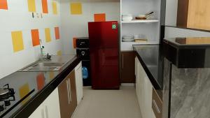 a small kitchen with a red refrigerator in it at casavina studio 304 private kitchen, Near beach in Canggu