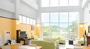 a living room with chairs and a large window at Hotel SP Haruno in Shinkawa