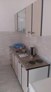 a kitchen with a sink and a counter top at Apartments Sadina in Skradin +32 photos