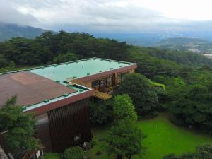 an overhead view of a building with a swimming pool at Kirishima Onsen Ryokojin Sanso in Kirishima