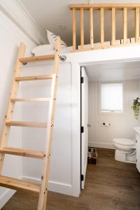a bathroom with a loft bed and a toilet at Stay Portland - The Tiny Farmhouse on Alberta in Portland +37 photos