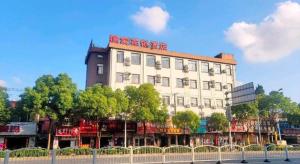 a large white building on the side of a street at Shanghai Jiejia hotel in Shanghai