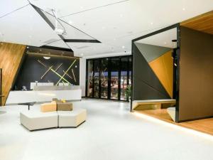 a living room with a couch and a table at IU Hotels·Nanning Zoo Metro Station RT-Mart in Nanning
