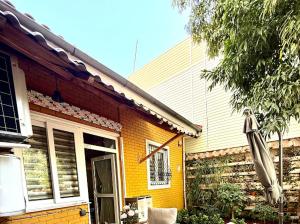 a yellow house with an umbrella in front of it at Antalya merkez kaleiçi muhteşem size özel bahçeli özel VİLLA in Antalya