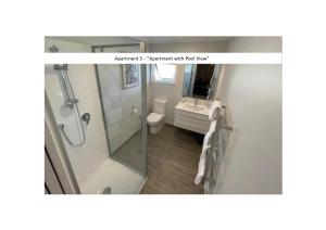 a bathroom with a shower and a toilet and a sink at Stay n Play n Russell in Russell +20 photos