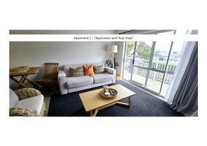 a living room with a couch and a table at Stay n Play n Russell in Russell