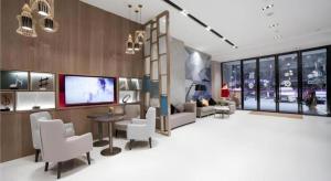 a living room with white chairs and a tv at Echarm Hotel Changde Chaoyang D5 District in Changde