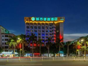 a hotel building with a lit up sign on it at City Comfort Inn Zhanjiang Mazhang Pedestrian Street High-speed Railway West Station in Tchia-k'am