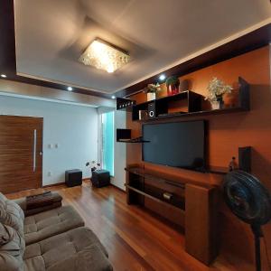 a living room with a large flat screen tv at Cobertura COP30 in Belém