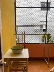 a bowl sitting on a table in front of a window at Green home in Da Nang