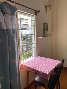 a table in a room with a window at Green home in Da Nang +1 photo