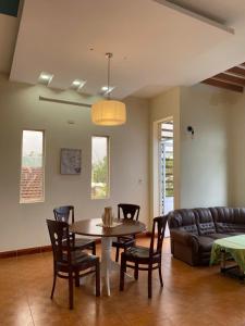 a living room with a table and chairs and a couch at Green home in Da Nang