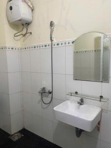 a bathroom with a sink and a mirror at Green home in Da Nang