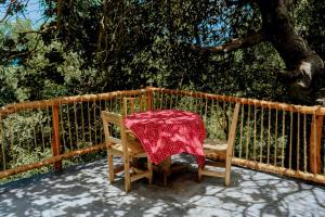 a table with a red table cloth on a chair at Kimulimuli Green Heaven in Kilindoni