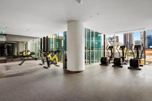 a gym with cardio equipment and a view of the city at Home in the Sky 2BR Apt with City and River View in Melbourne
