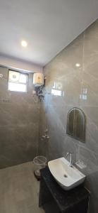 a bathroom with a sink and a mirror at Hotel Nakshatra in Sawāi Mādhopur