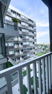 a large apartment building is seen from a balcony at WV 30 Bright 2BR Escape in Sampong