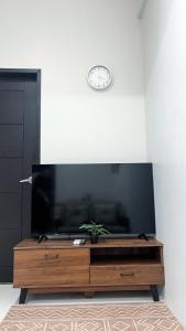 a living room with a large flat screen tv at WV 30 Bright 2BR Escape in Sampong