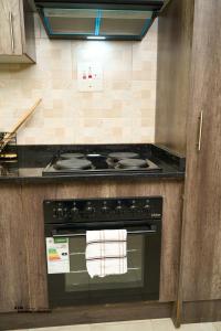 a kitchen with a stove top oven in a kitchen at K&M Luxury Apartments Solwezi in Solwezi