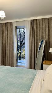 a bedroom with a bed and a window at Апартаменти La Storia in Kamianets-Podilskyi +21 photos