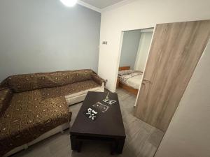 a small room with a bed and a table at Jordans appartment in Thessaloniki