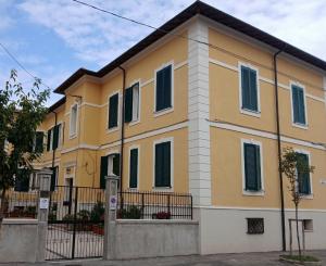 a yellow house with a fence in front of it at Marruvium 1937's in Avezzano