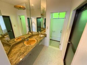 a bathroom with two sinks and a large mirror at ジーアール柳井 in Yanai +32 photos