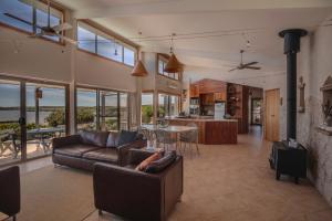 a living room with a couch and a table at Moonrise Cove in Pelican Lagoon